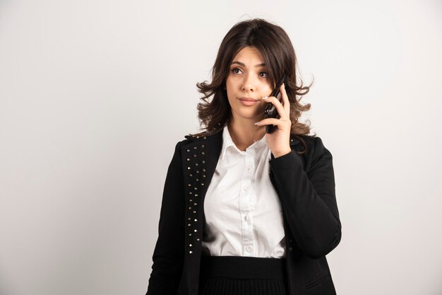 Female employee talking on telephone about project