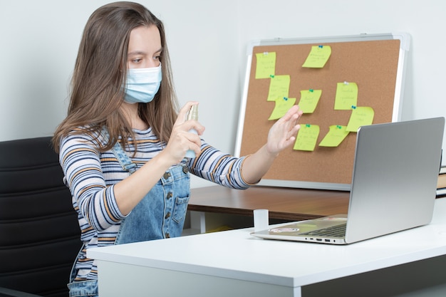 Female employee working in isolated conditions and using preventive actions