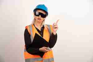 Free photo female engineer in glasses pointing on white background. high quality photo