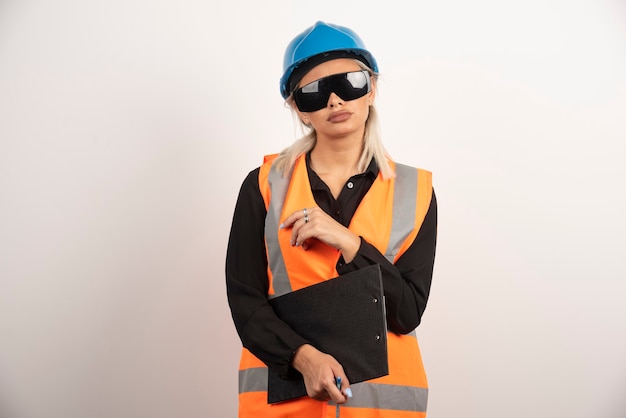 Female engineer in glasses posing on white background. High quality photo