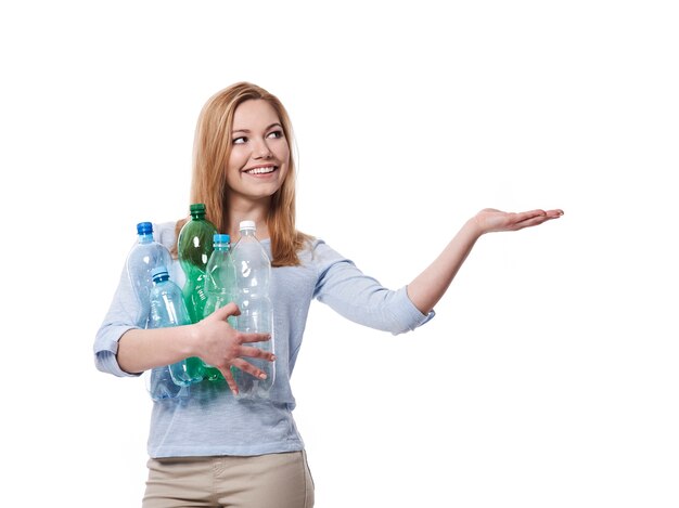 Female environmentalist with plastic bottles showing on copy space