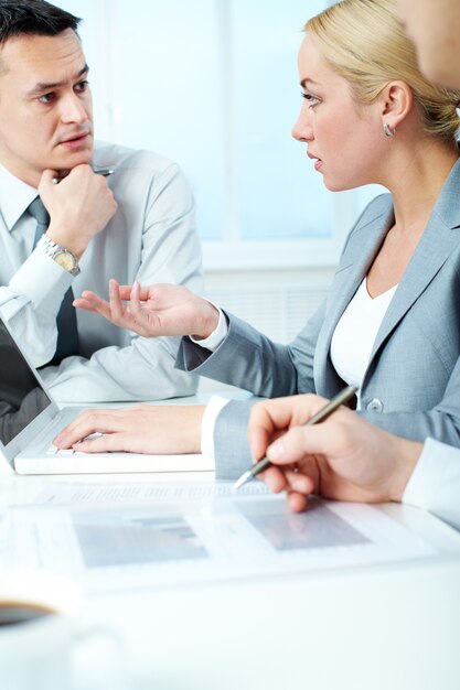 Female executive interacting with teammate