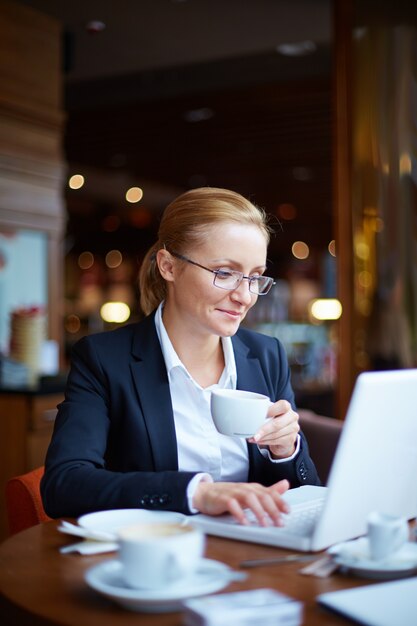 Female executive working in a coffee shop
