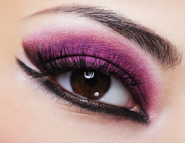 Female eye with purple bright make-up