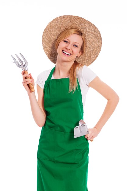 Female farmer holding gardening equipment