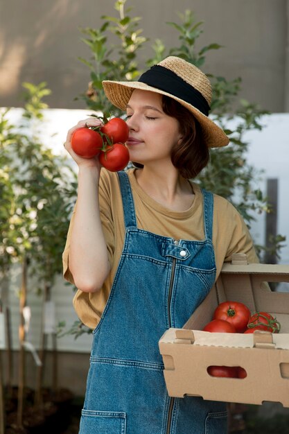 female farmer holding some tomatoes