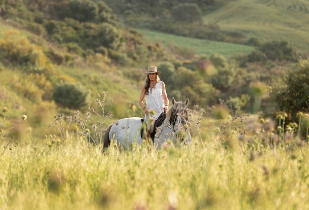 Female farmer horseback riding