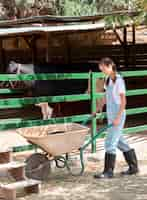 Free photo female farmer taking care of a cow