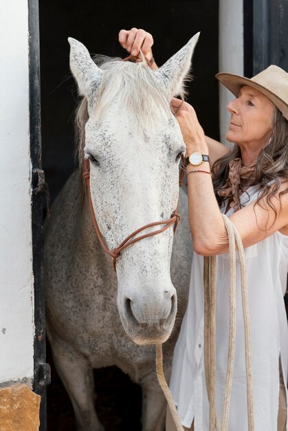 Female farmer with her horse at the ranch