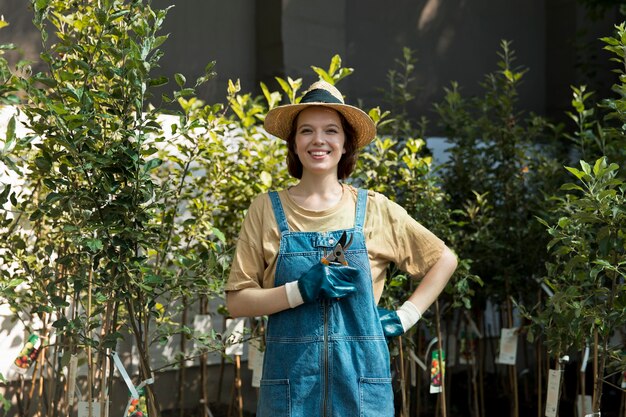 Female farmer working alone in her greenhouse