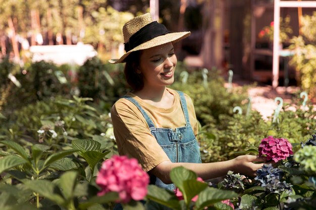 Female farmer working alone in her greenhouse
