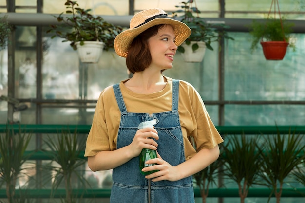 Free photo female farmer working in a greenhouse