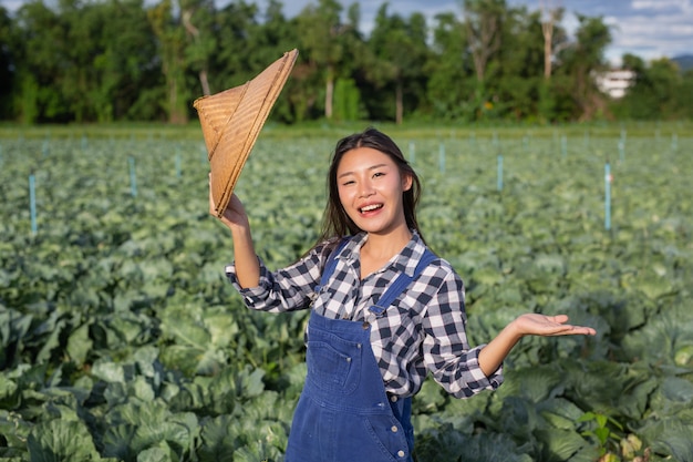 自由女性农民满意照片作物在他们的花园。