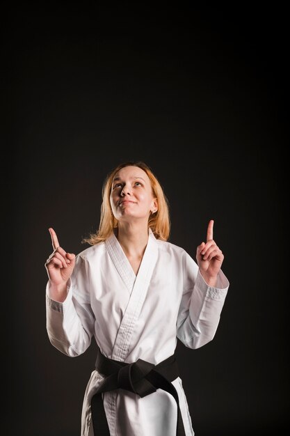 Female fighter pointing up medium shot