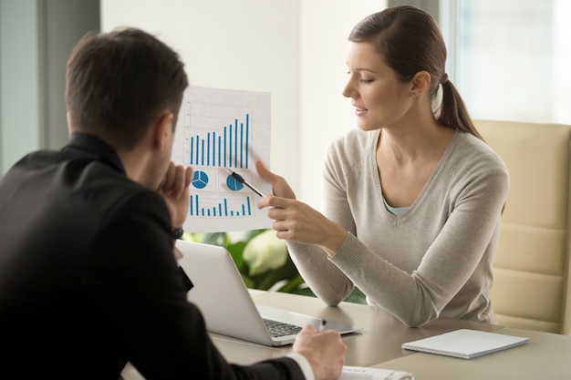Female financial adviser explaining business plan