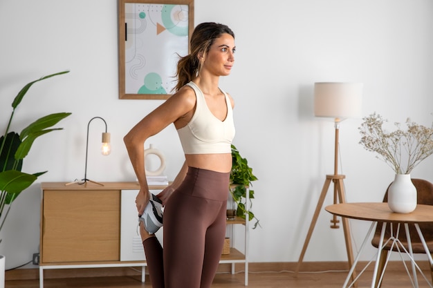 Female fitness instructor working out at home