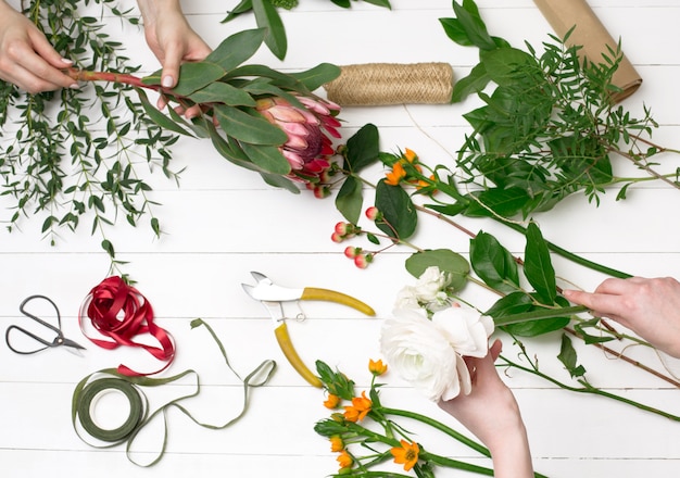 Female florist making beautiful bouquet at flower shop