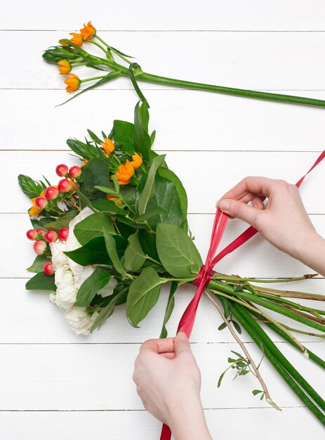 Female florist making beautiful bouquet at flower shop