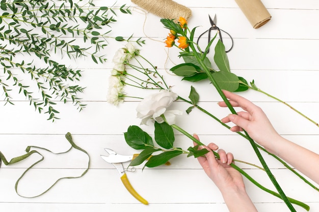 Female florist making beautiful bouquet at flower shop