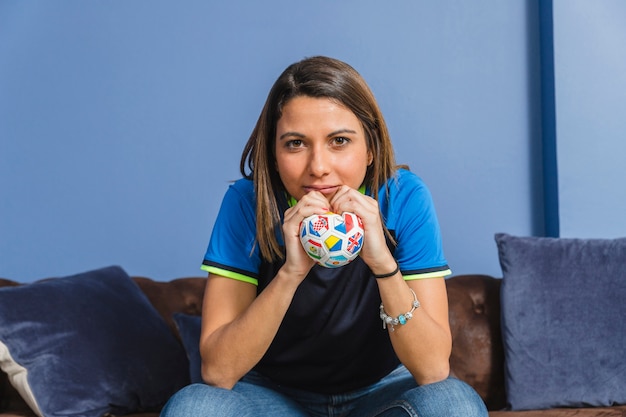 Free photo female football fan on couch