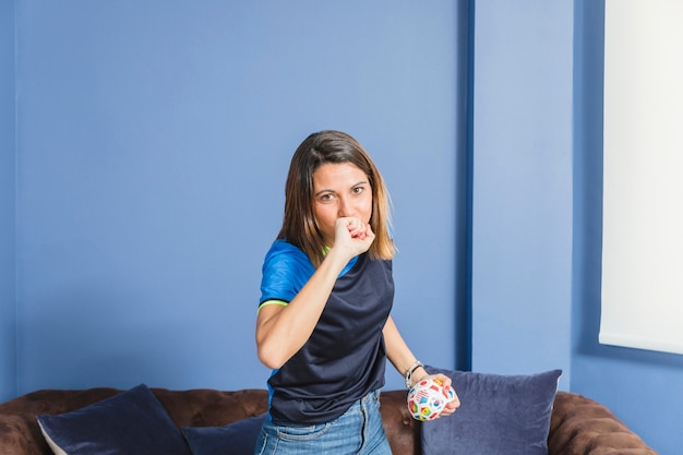 Free photo female football fan on couch