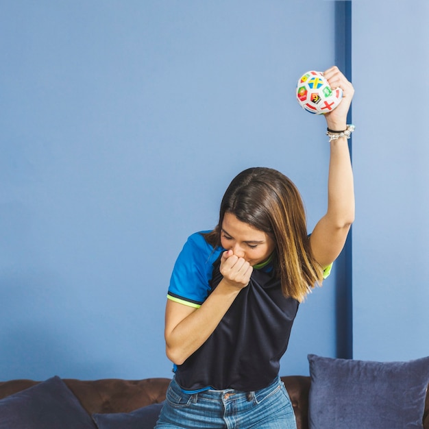 Free photo female football fan on couch