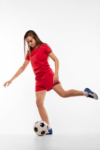 Female football player kicking ball