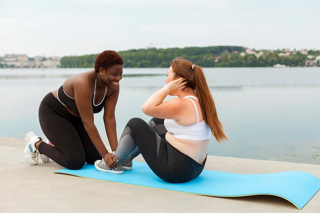 Free photo female friends exercising outdoors