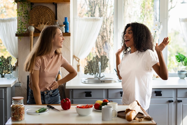 Female friends having fun together in the kitchen