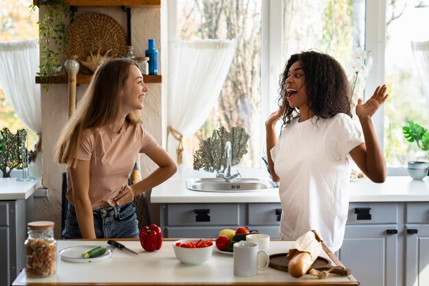 Female friends having fun together in the kitchen