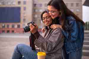 Free photo female friends having fun together with camera