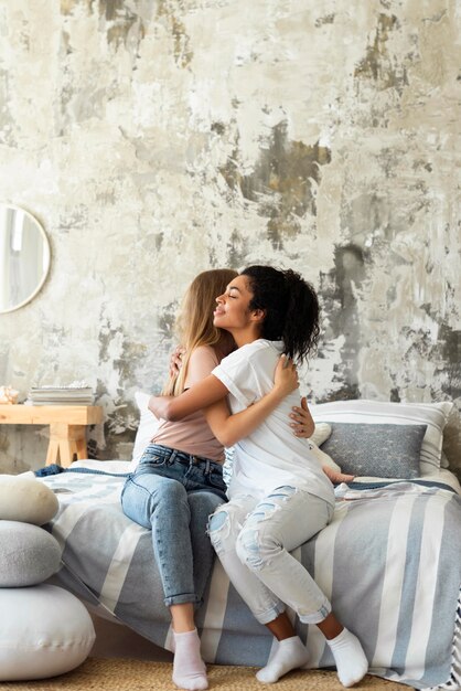 female friends hugging each other with copy space