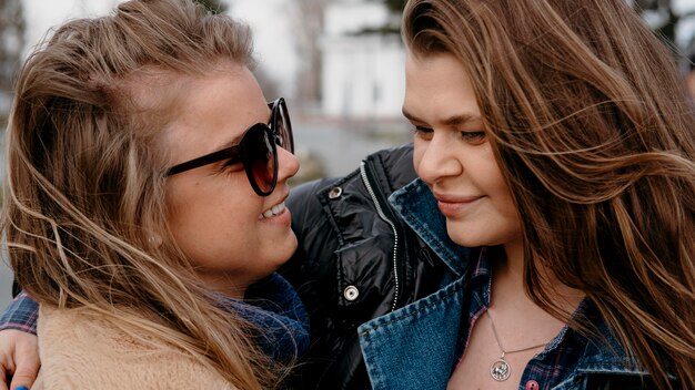 Female friends hugging together outdoors