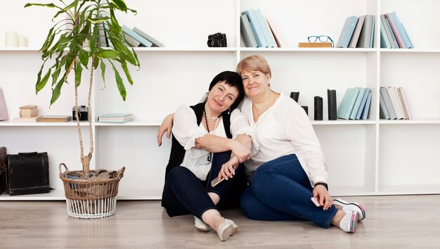 Female friends in a studio with books