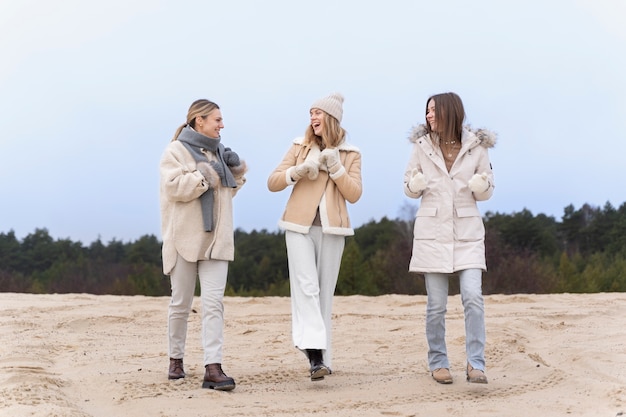 Female friends taking a walk on the beach while traveling