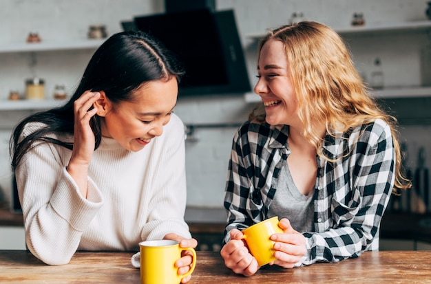 Free Photo | Female friends with cups of tea chatting