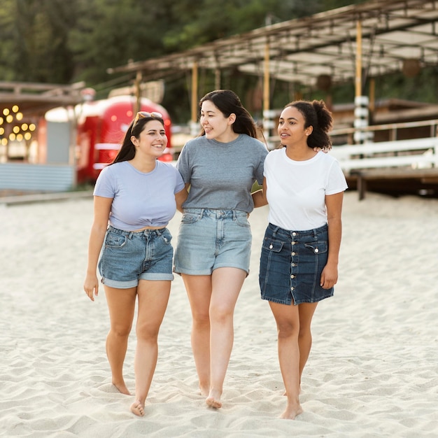 Free photo female friends together on the beach