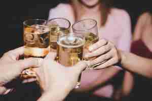 Free photo female friends with glass beer in a party