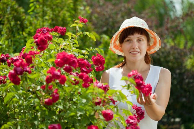 Female gardener in roses plant