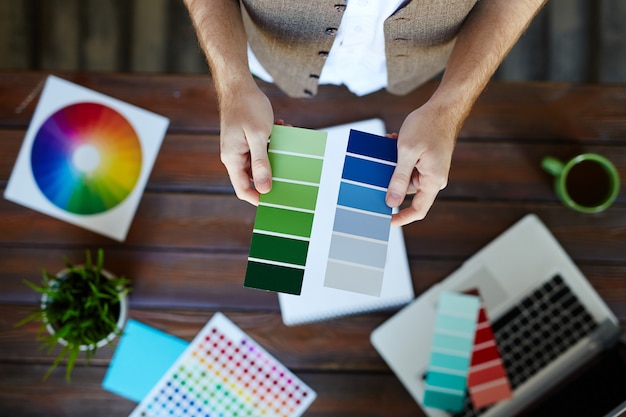 Female graphic designer choosing pantone colors