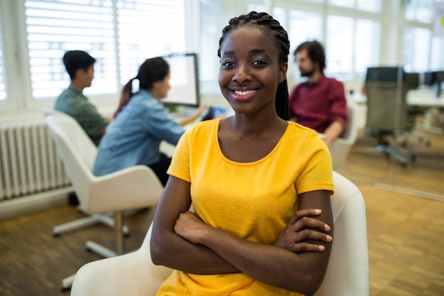 Female graphic designer sitting with arms crossed