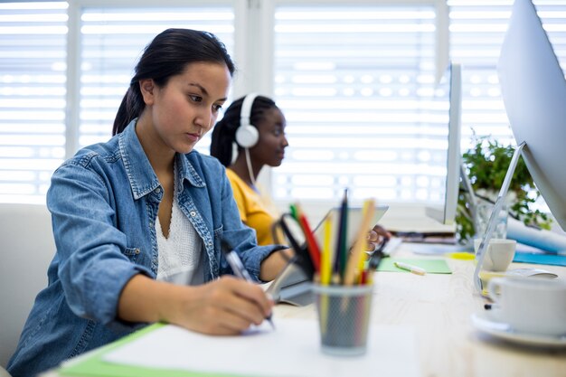 Female graphic designer using digital tablet