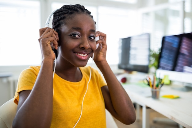 Female graphic designer wearing headphones