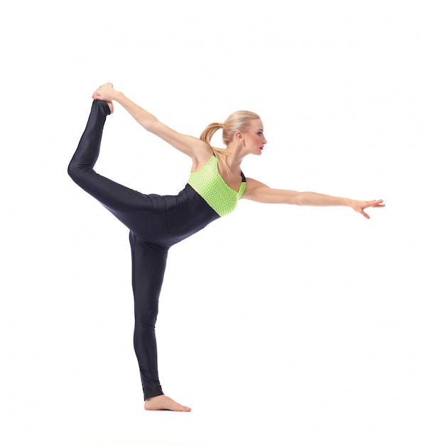 female gymnast posing gracefully exercising on white