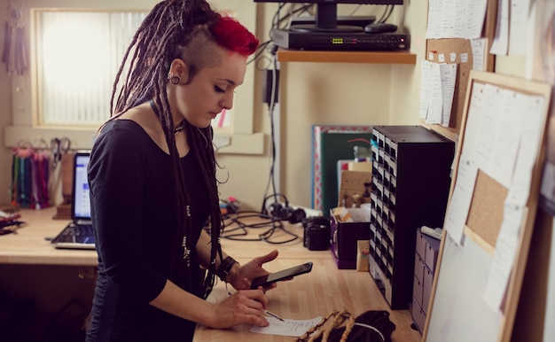 Female hairdresser using mobile phone