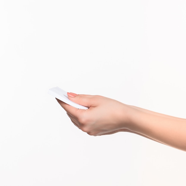 Female hand holding blank paper for records on white.