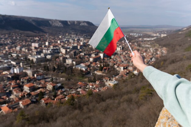 Female hand holding fabric flag of bulgaria