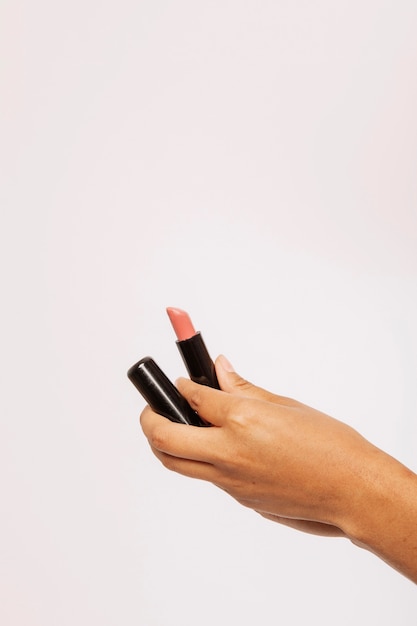 Female hand holding a lipstick