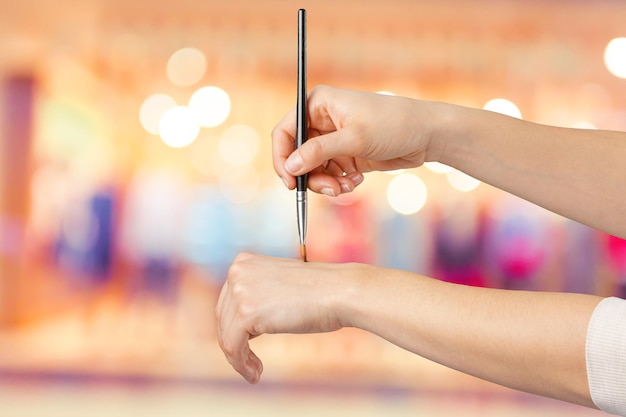 Female hand holding a professional makeup brush