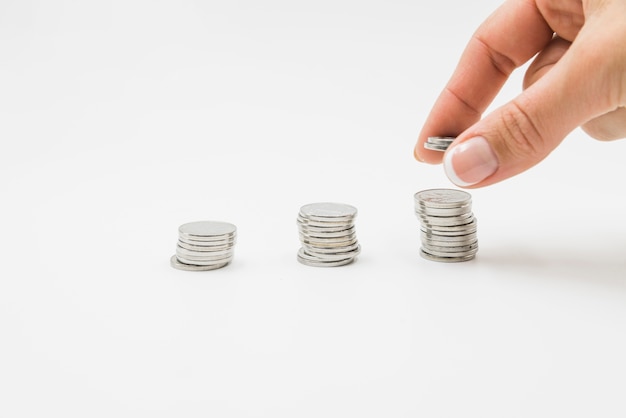 Free photo female hand putting coins on stack